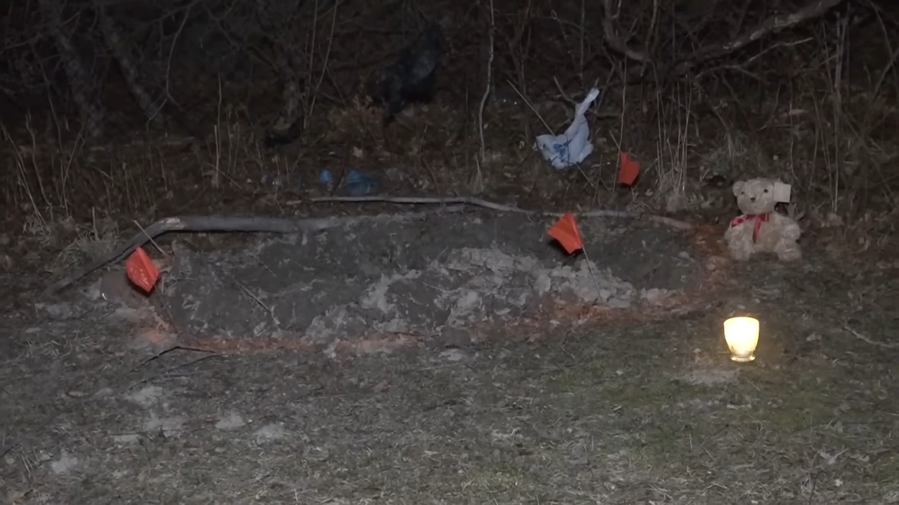 A shallow sedate astatine nighttime with a teddy bear, candle, and immoderate flags nearby