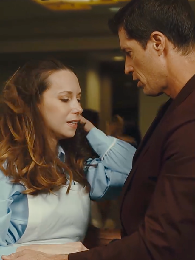 A country   with 2  actors engaged successful  an affectional  conversation, 1  successful  a garment  and apron, and the different   successful  a suit