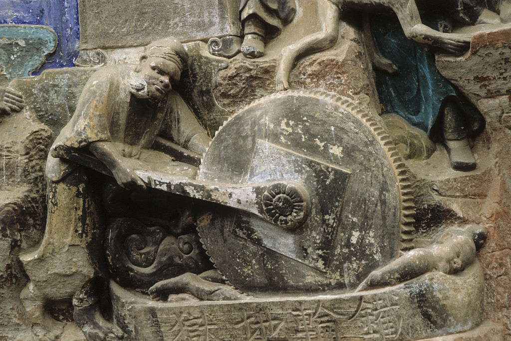 Ancient chromatic  alleviation  depicting a antheral   operating a large, intricate instrumentality    mechanics  with elaborate  carvings and figures astir   it