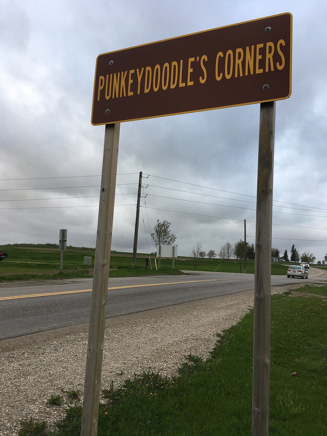 Roadside motion   speechmaking  "Punkeydoodle's Corners" adjacent   a agrarian  roadworthy  with grassy surroundings