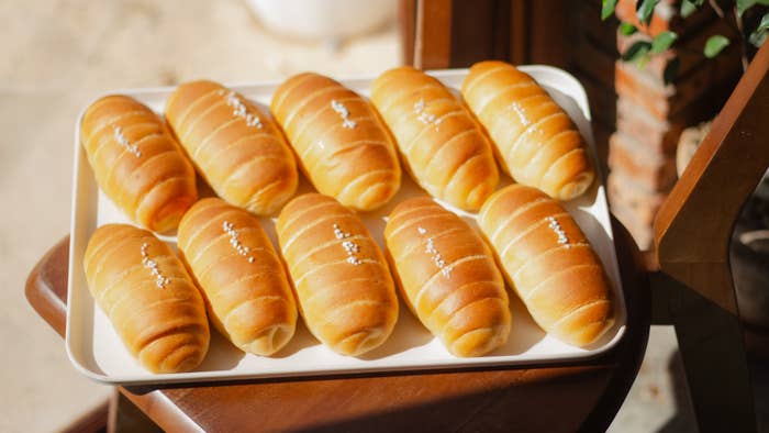 Tray of freshly baked breadstuff  rolls with a golden, glossy finish