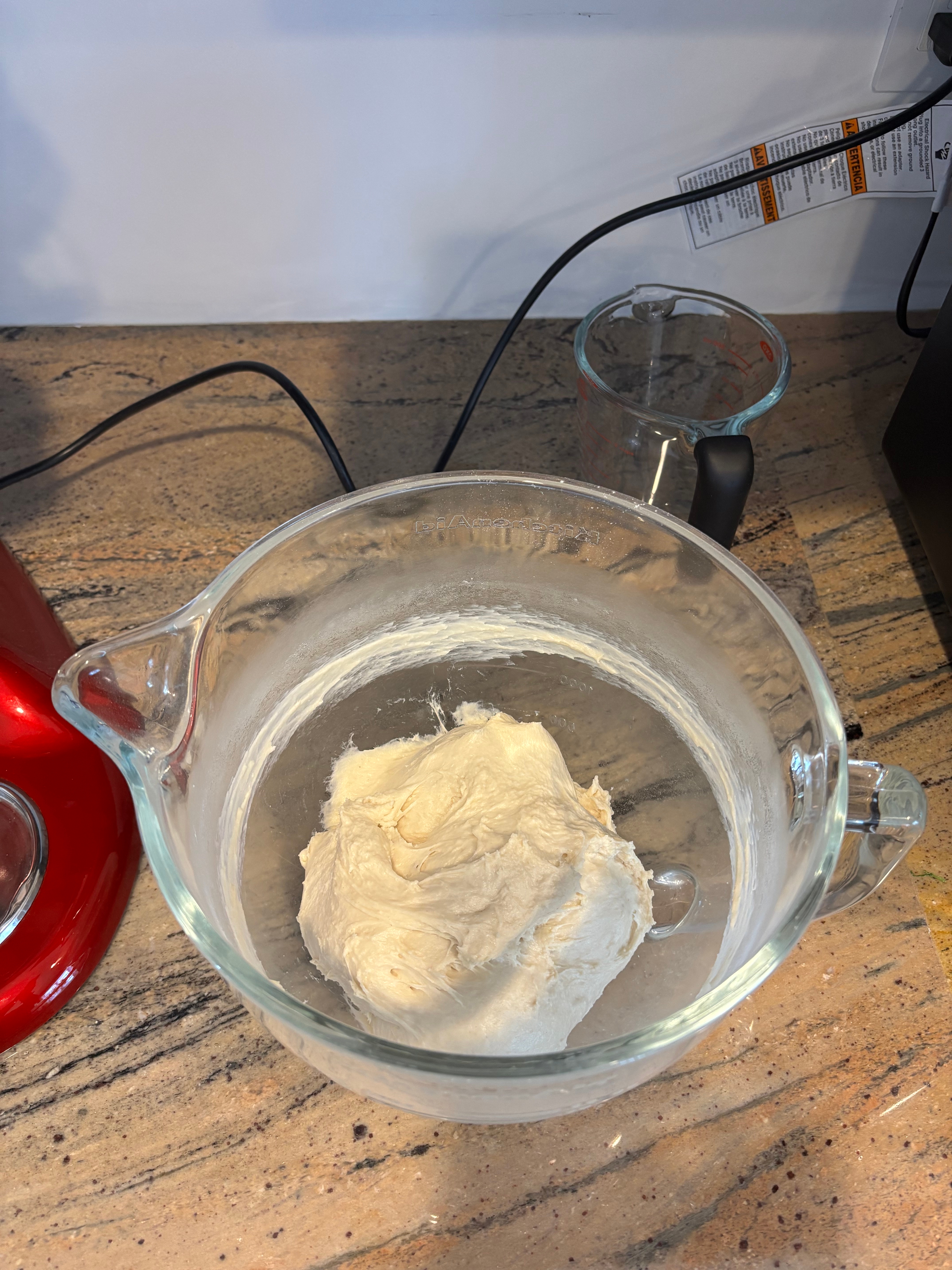 A vessel  of dough rests connected  a room  counter, acceptable   for kneading oregon  further preparation