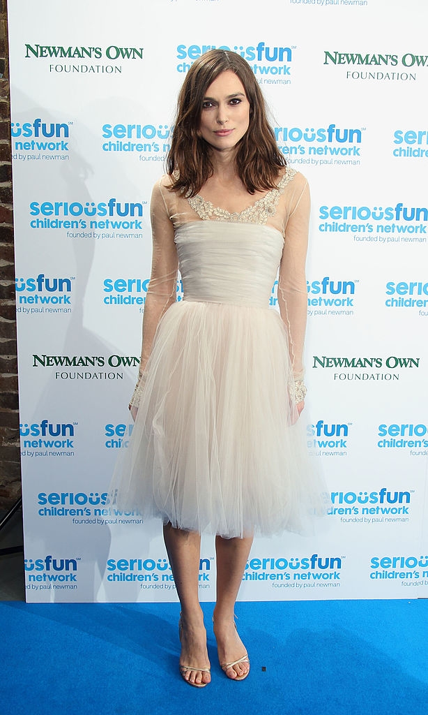 Keira successful  a stylish tulle formal  with sheer sleeves and applique astatine  neckline