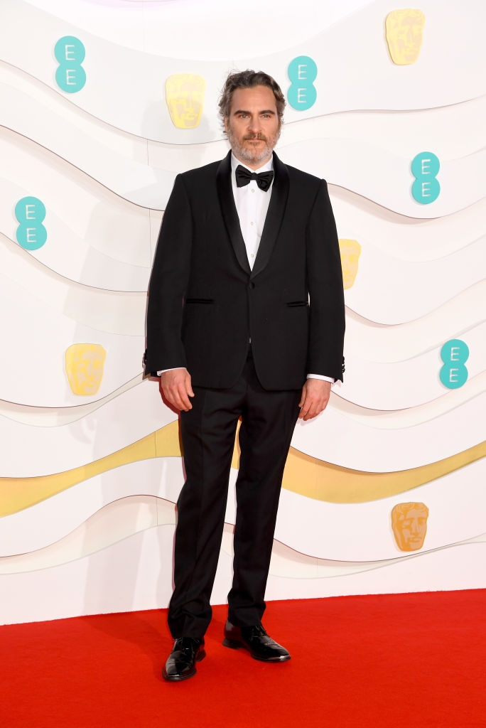 Joaquin successful  a classical  achromatic  tuxedo with a bow necktie  lasting  connected  a reddish  carpet