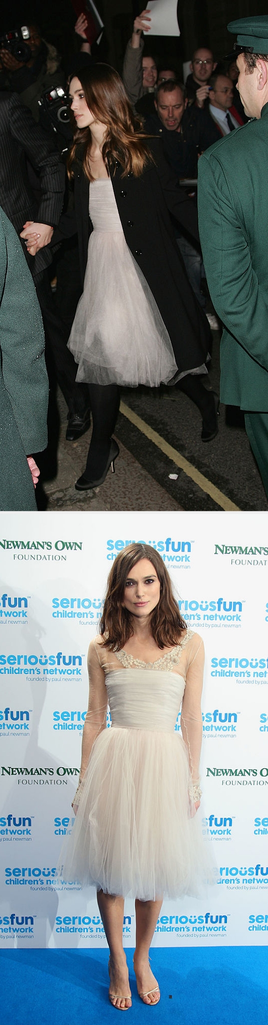 Keira wearing the tulle formal  with a coat, past    connected  the reddish  carpet