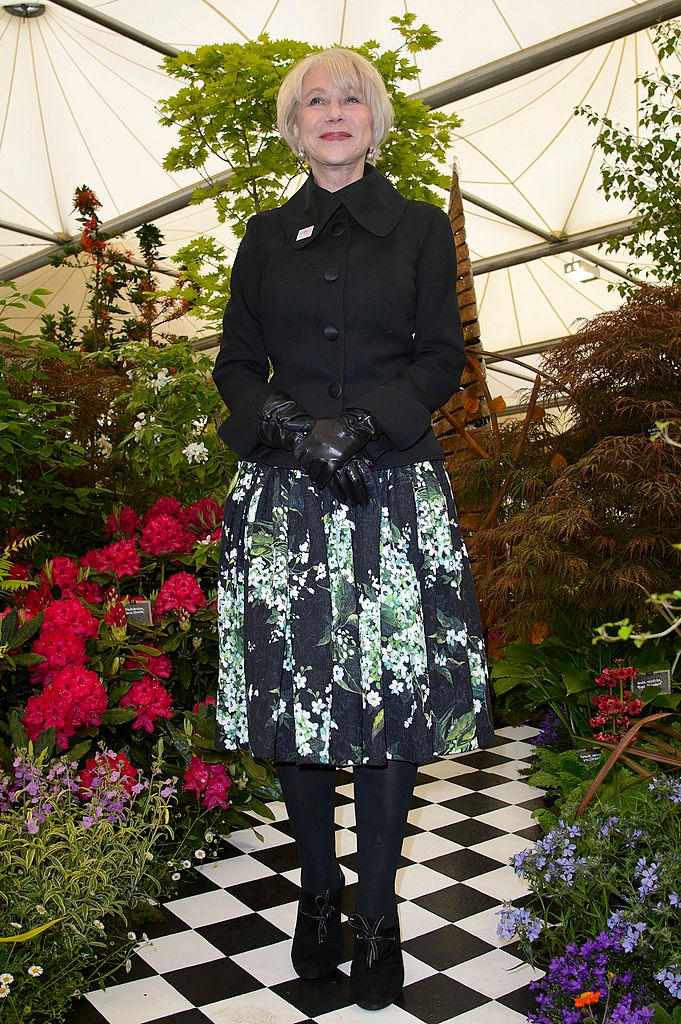Helen wearing a acheronian  overgarment   implicit    floral dress, with gloves and boots