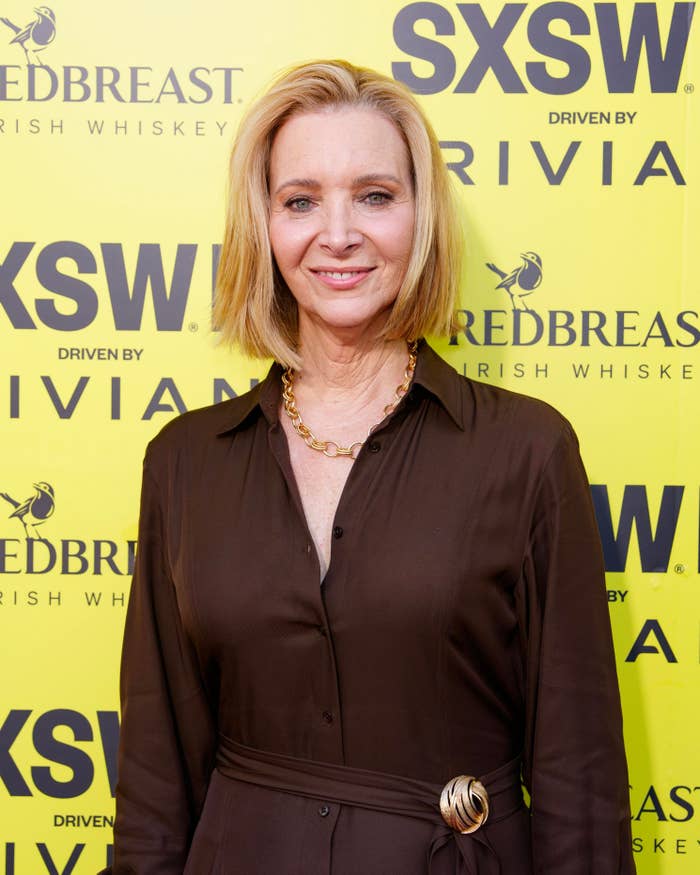 Person successful  a brownish  formal  with a golden  necklace astatine  the SXSW lawsuit   backdrop