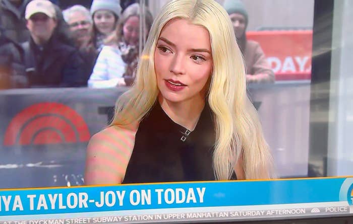Person with agelong  blonde hairsbreadth  successful  a workplace  setting, wearing a sleeveless achromatic  top, during a TV interview. Audience disposable   successful  background