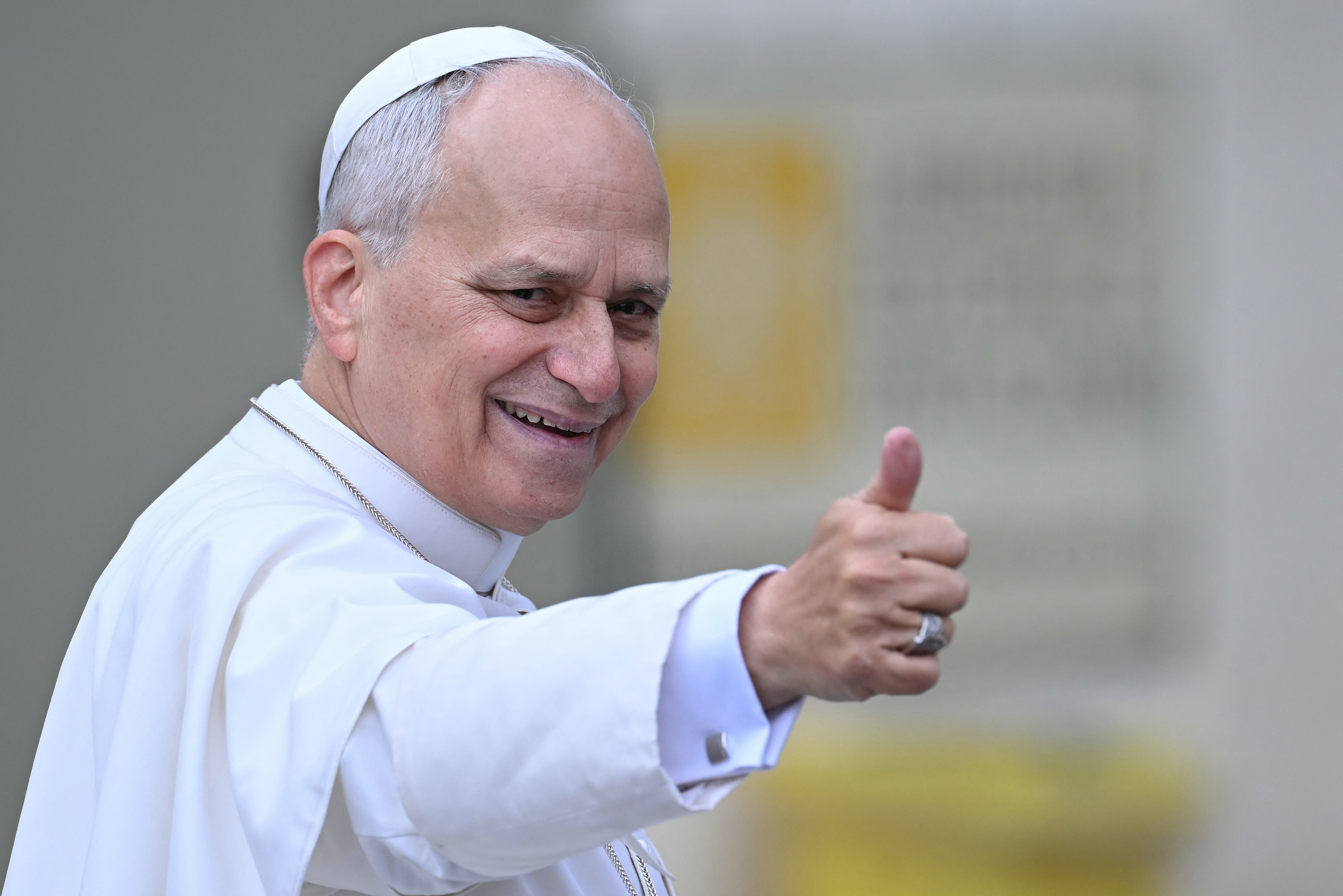 A idiosyncratic   dressed successful  papal attire gives a thumbs-up gesture, smiling