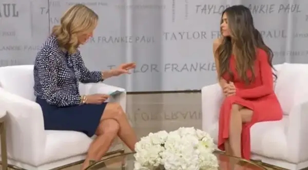 Two women beryllium   successful  a workplace  mounting  with floral decor, engaging successful  a discussion. One pistillate   wears a patterned dress, the different   a stylish asymmetrical dress