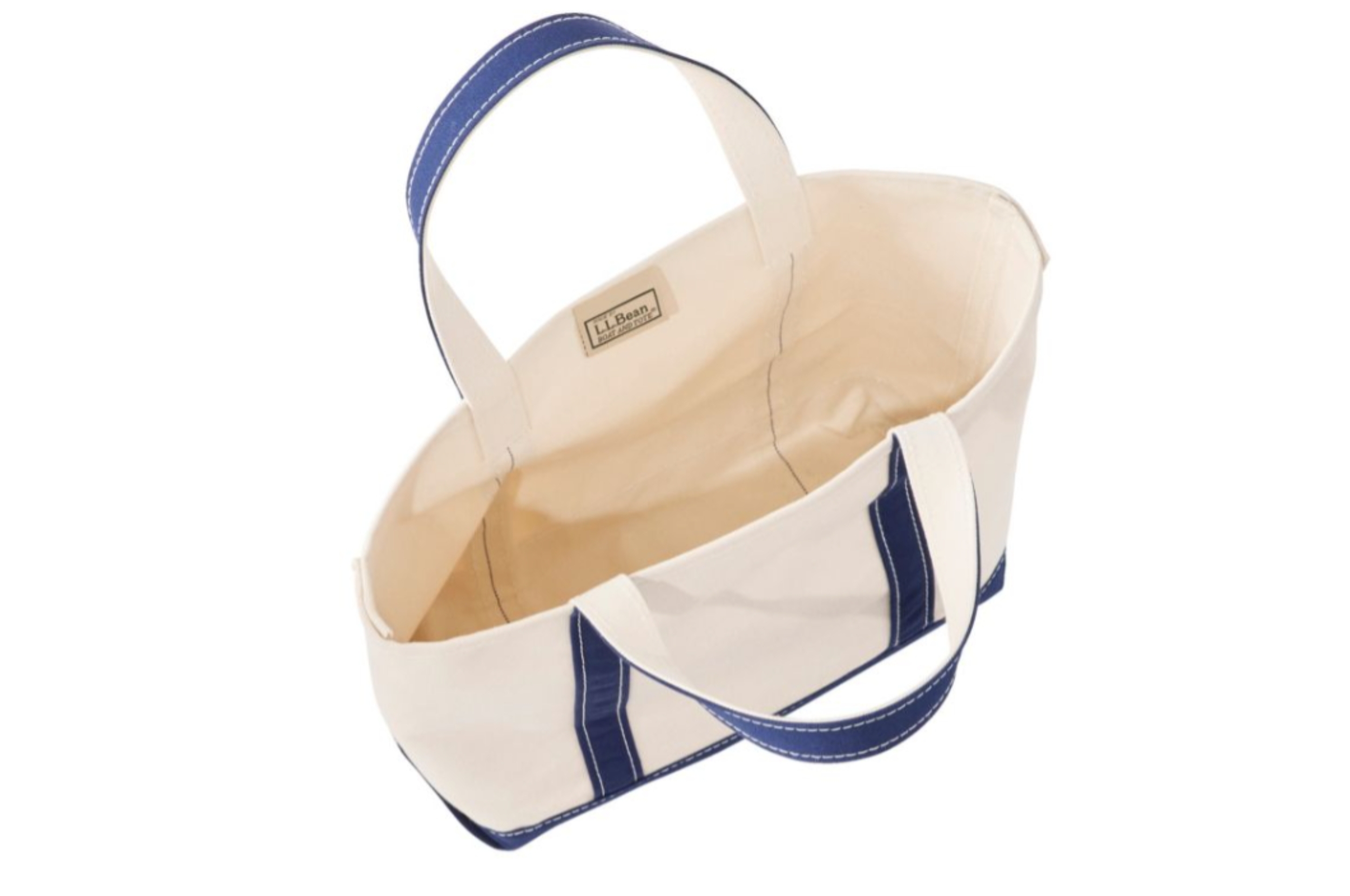 Open beige canvas tote container with navy handles, featuring a tiny interior pouch and a statement that reads "L.L.Bean."
