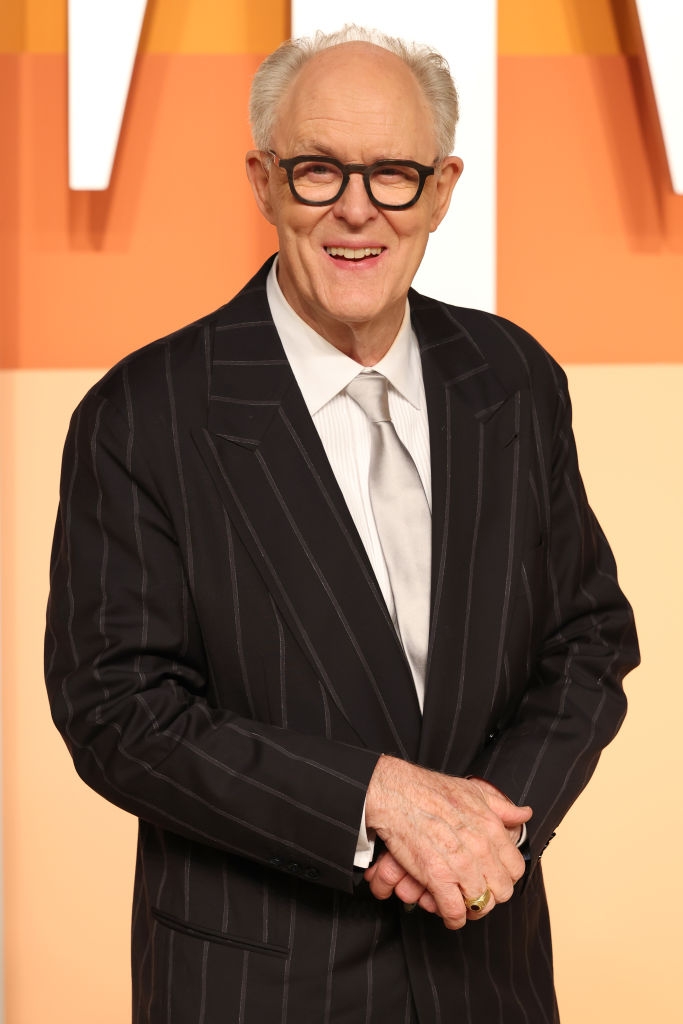 Person successful  a pinstripe suit   and necktie  astatine  a ceremonial  lawsuit   smiling astatine  the camera