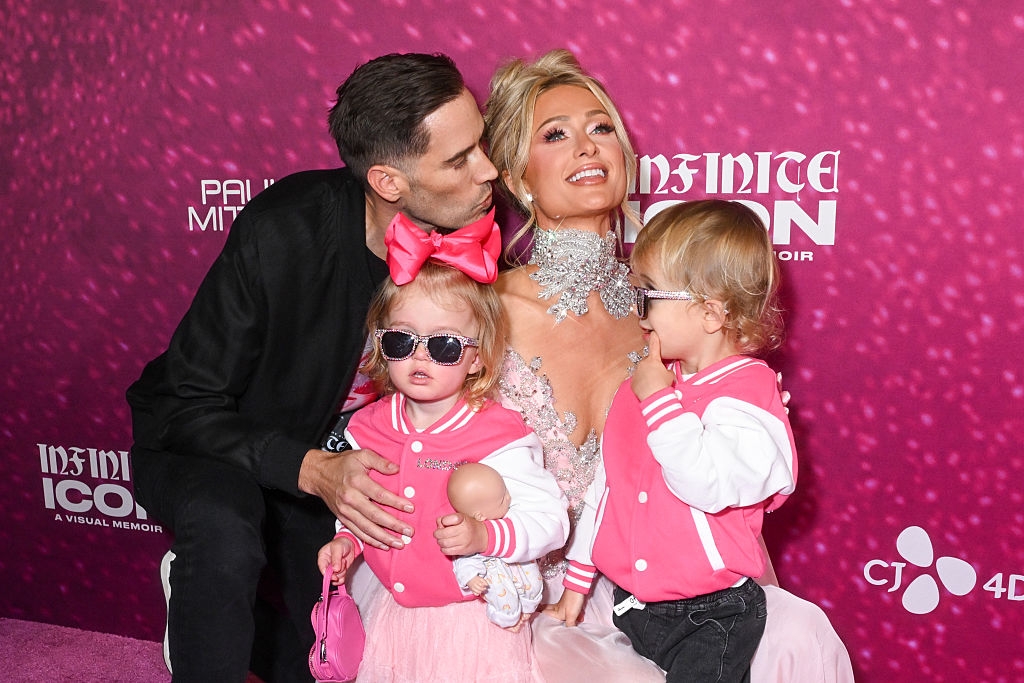 Celebrity poses connected the reddish carpet successful a sparkling gown with antheral and 2 children successful matching outfits