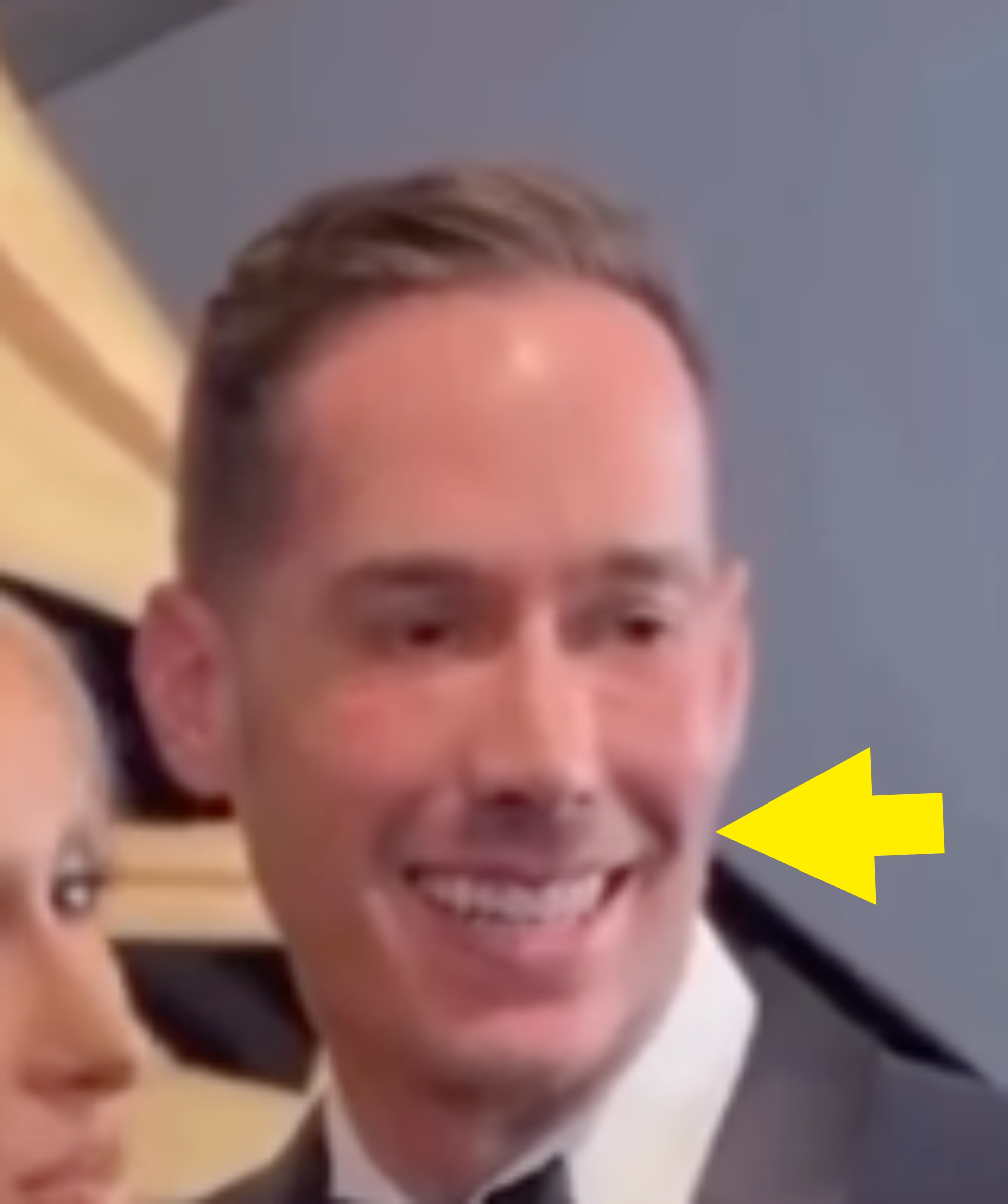 A idiosyncratic smiles connected the reddish carpet, wearing a sleek suit