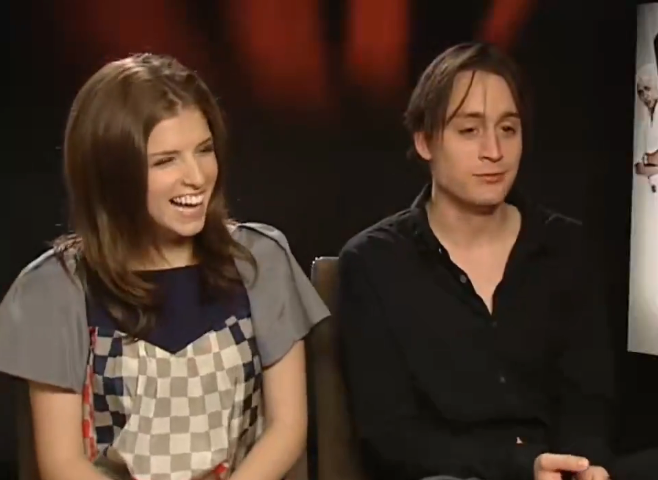 Anna laughing in an interview, portion Kieran speaks sincerely