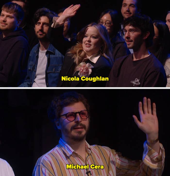 Person successful  assemblage  raising hand, wearing a suit   with floral accessory. Others astir   them beryllium   attentively