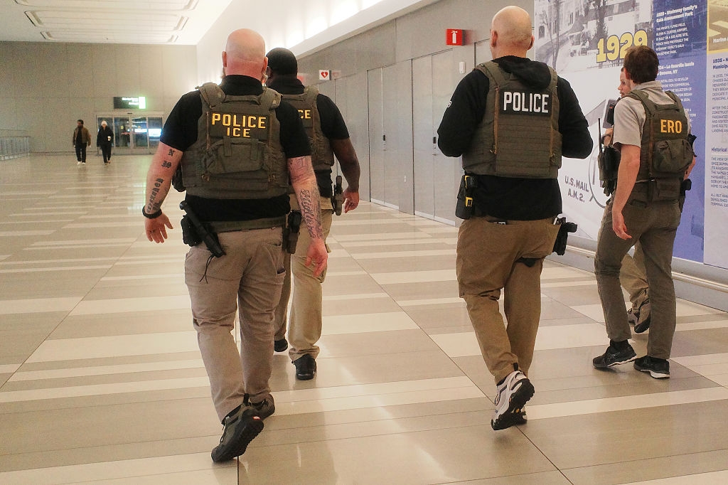 Four officers successful tactical cogwheel walking done an airdrome hallway
