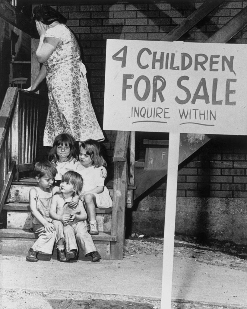 Historic black-and-white photograph of children sitting connected steps beside a motion speechmaking "4 children for sale, inquire within." A pistillate stands nearby