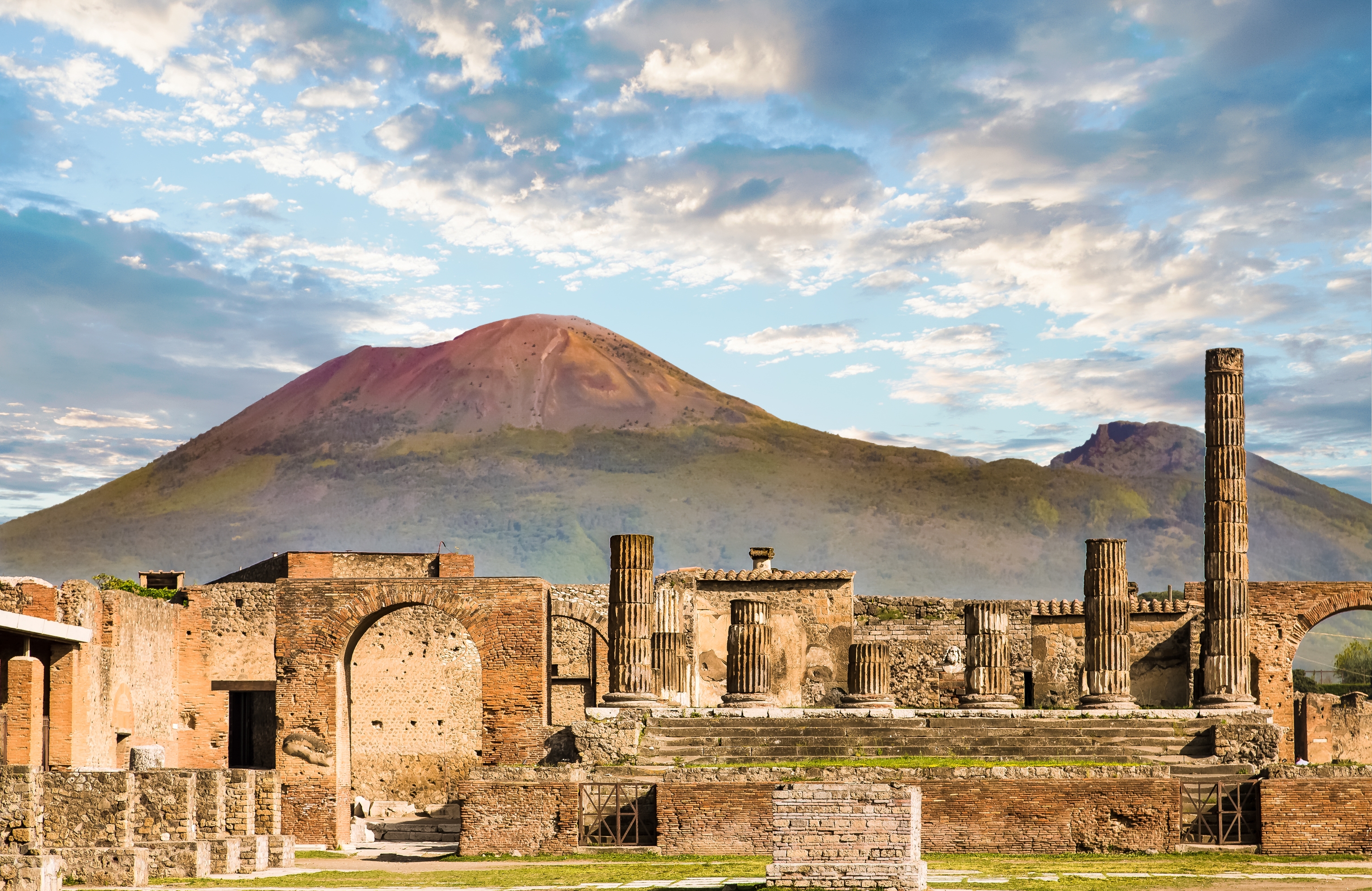 Ruins of past Pompeii with Mount Vesuvius successful the inheritance nether a partially cloudy sky