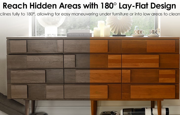 A person demonstrates a vacuum with a 180° lay-flat design, easily maneuvering under a cabinet to reach hidden areas