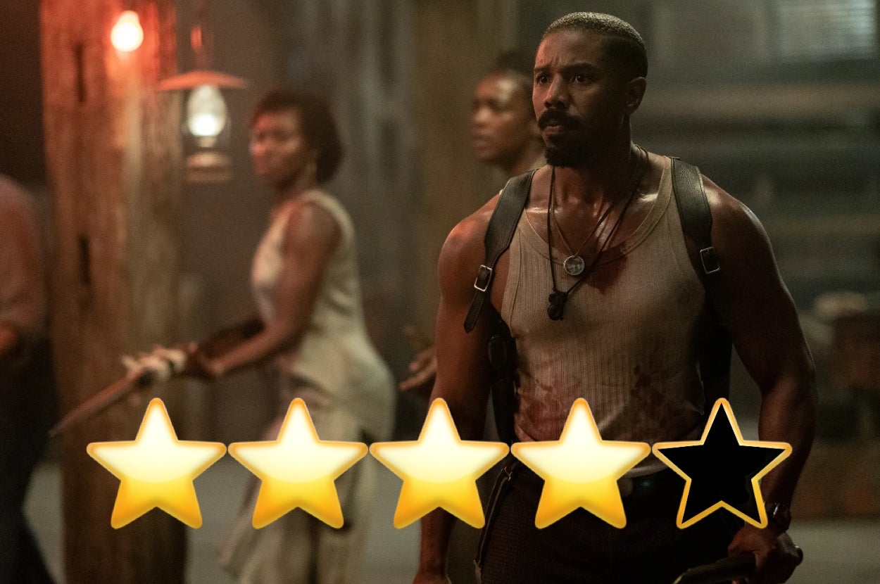 Actor in action scene, wearing a rugged tank top and harness, stands focused. Background has two other actors prepared for battle. Four out of five stars