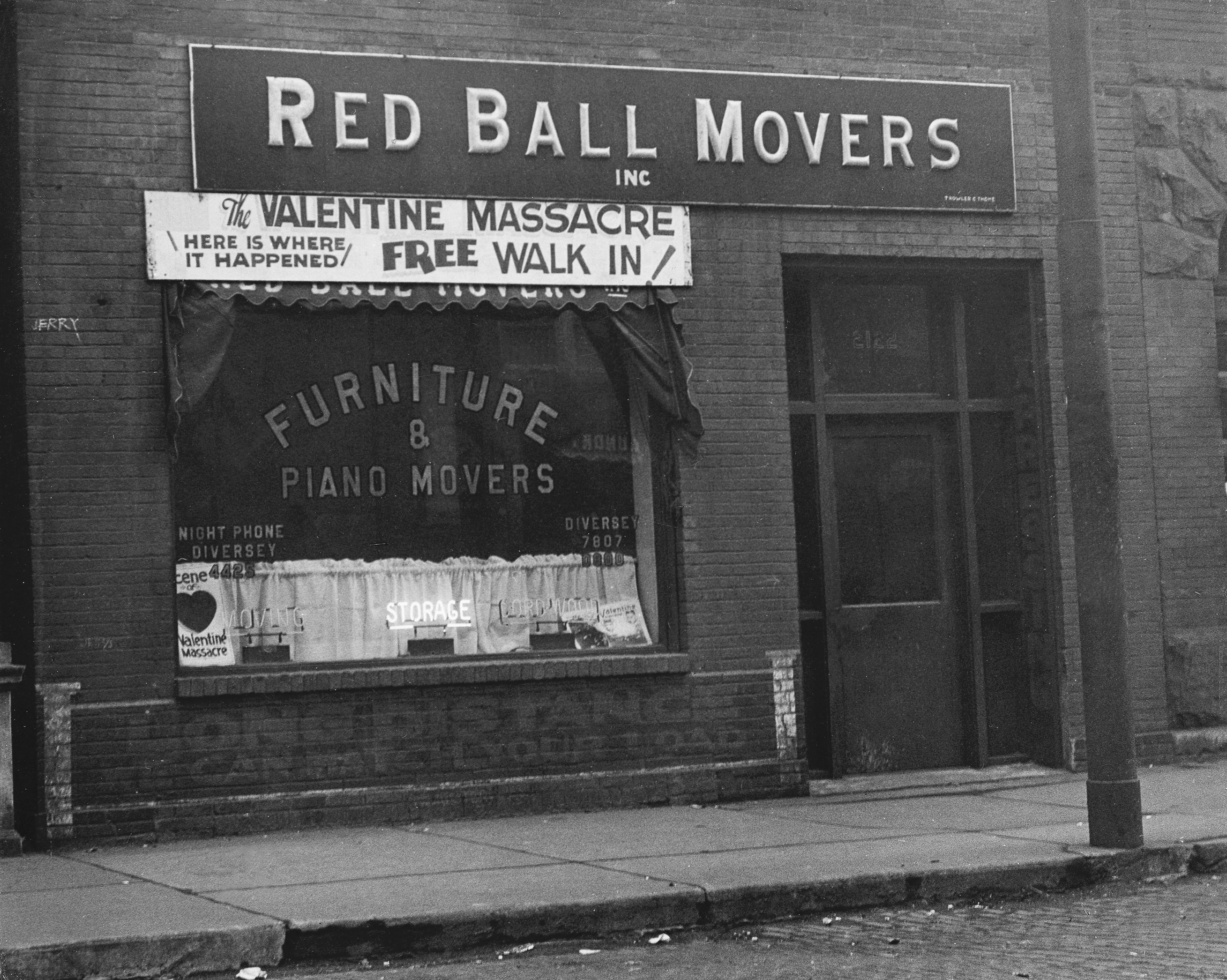 A storefront displays "Red Ball Movers" with a motion advertizing the determination of the St. Valentine Massacre, inviting a escaped walk-in tour