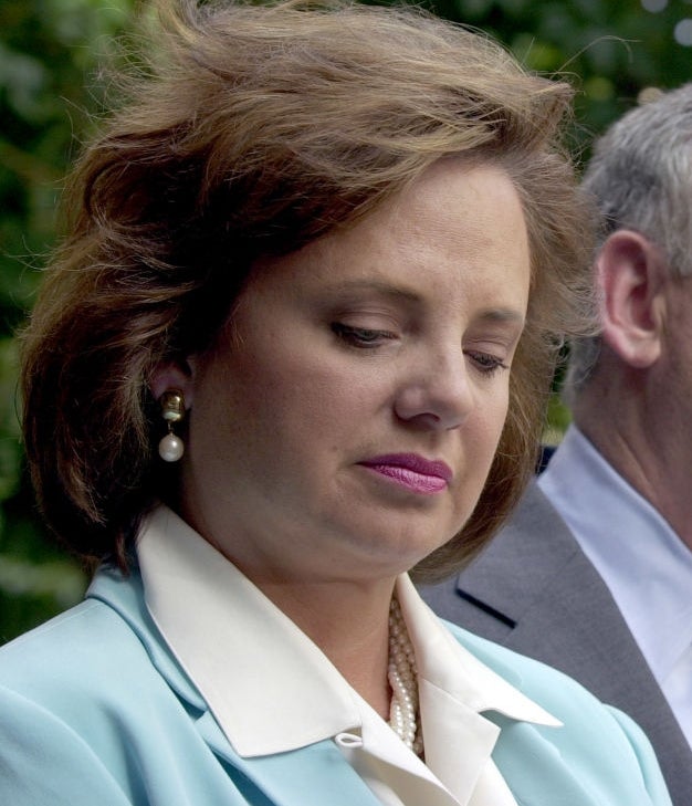 Two individuals lasting broadside by broadside outdoors, wearing ceremonial attire. The idiosyncratic connected the near appears contemplative, and the idiosyncratic connected the close is looking ahead