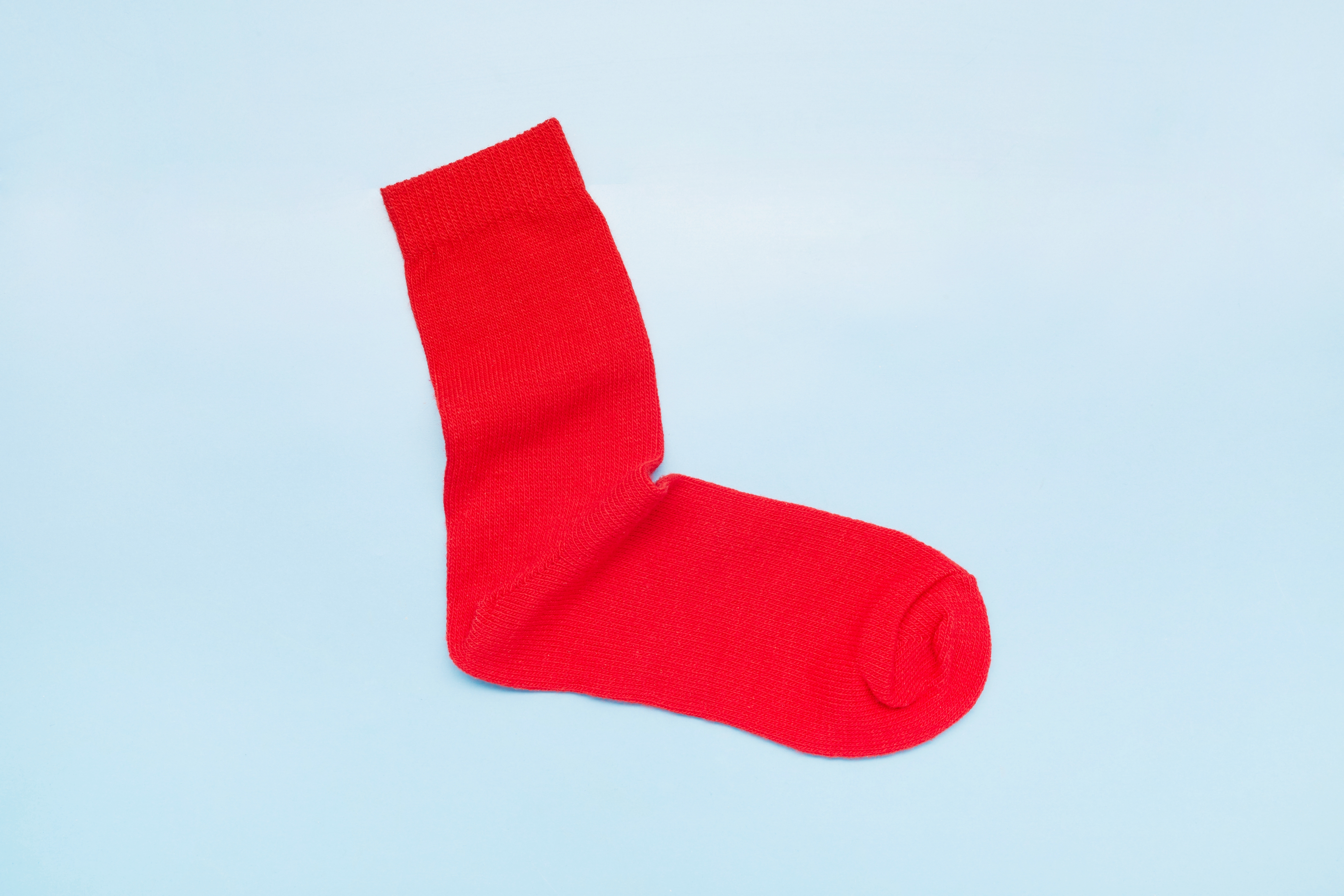 A azygous  sock is displayed connected  a level  surface, symbolizing minimalism and frugality for enactment    and wealth  topics