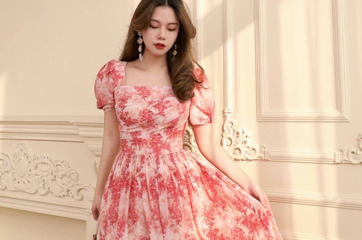 Two models showcase dresses: one in a floral, puff-sleeve gown; the other in an off-shoulder, strapless black dress