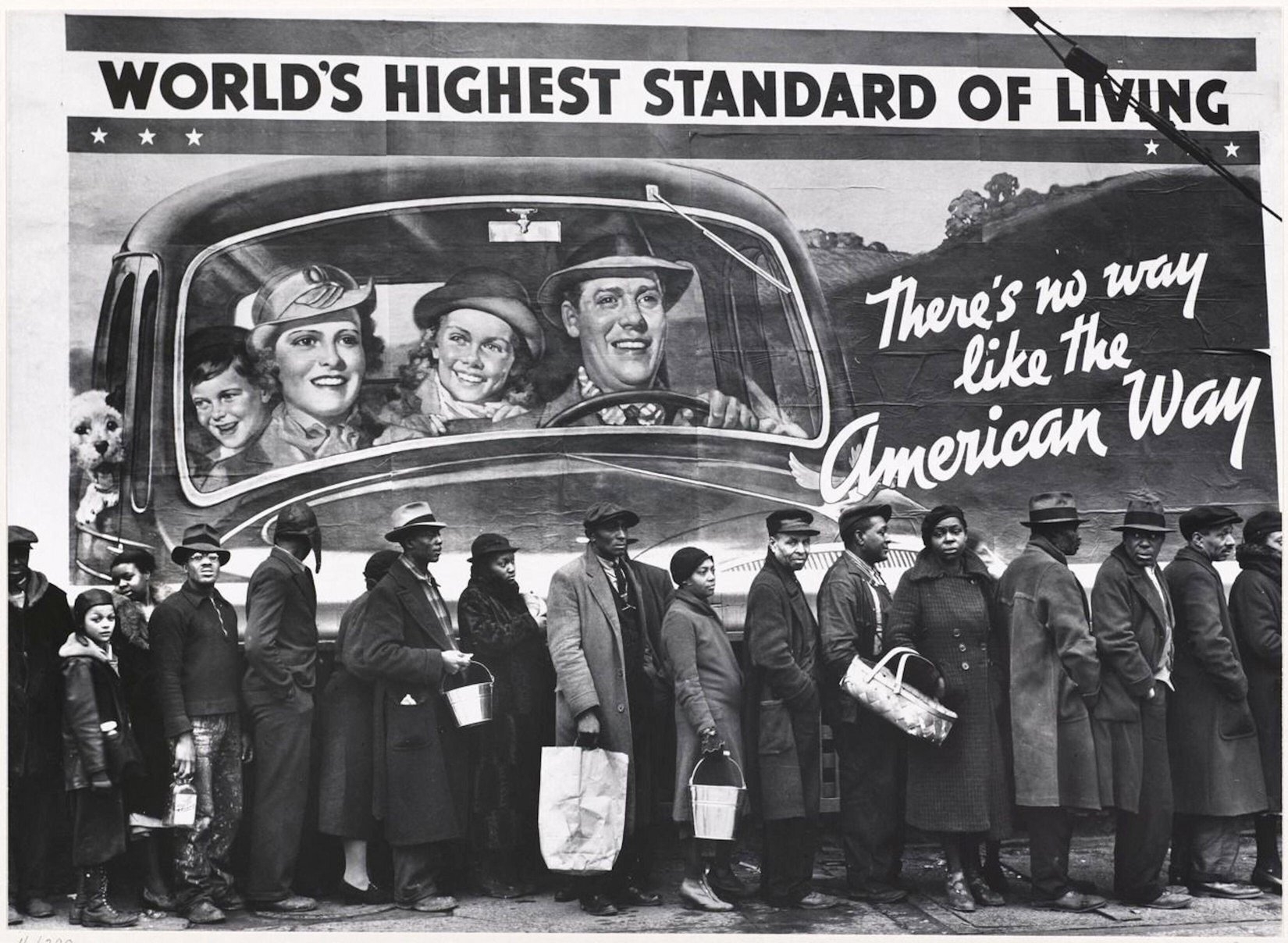 People hold successful enactment for assistance successful beforehand of a billboard showing a smiling household successful a car with the substance "World's Highest Standard of Living."