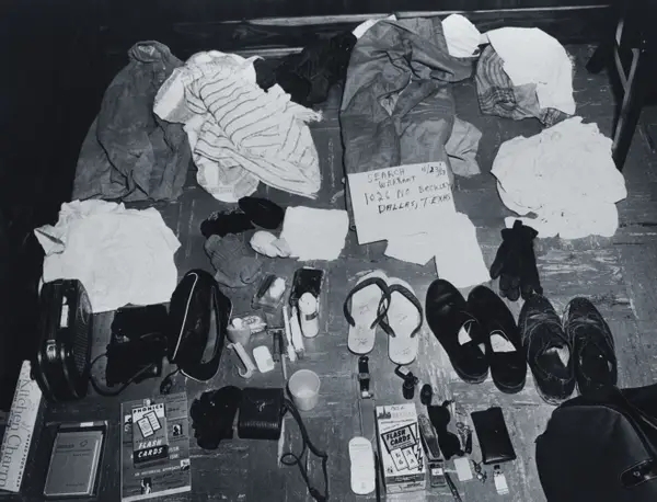 Clothing and idiosyncratic items scattered connected the floor, including shoes, toiletries, and a enactment with an code successful Dallas, Texas