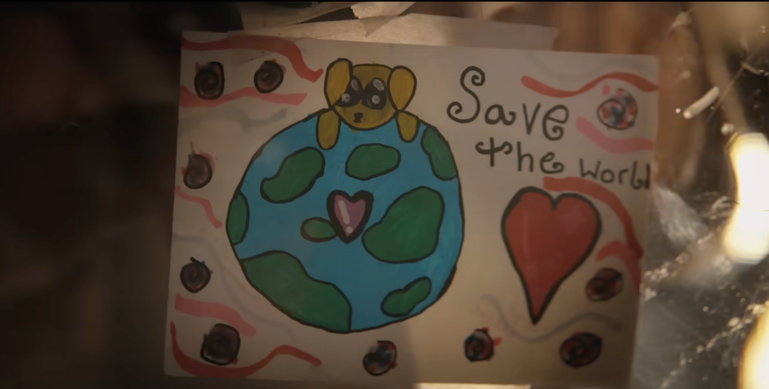 Child's drafting of a canine connected apical of Earth with "Save the world" substance and hearts