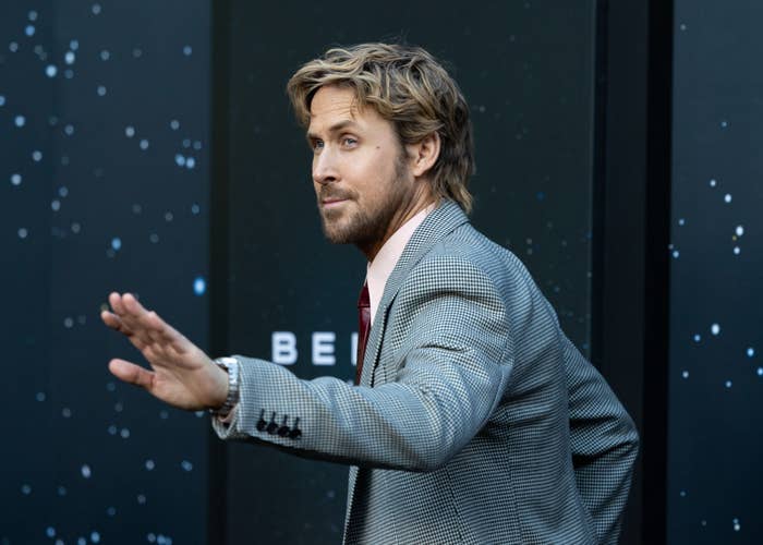 Person successful  a checkered suit   poses connected  a starry-themed backdrop, gesturing with 1  manus  guardant  astatine  a nationalist   event