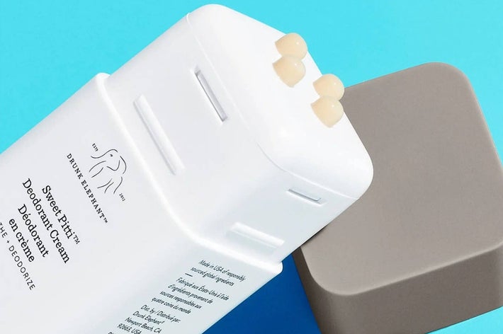 Deodorant cream stick labeled "Sweet Pitti" by Drunk Elephant, with visible text and product cap nearby