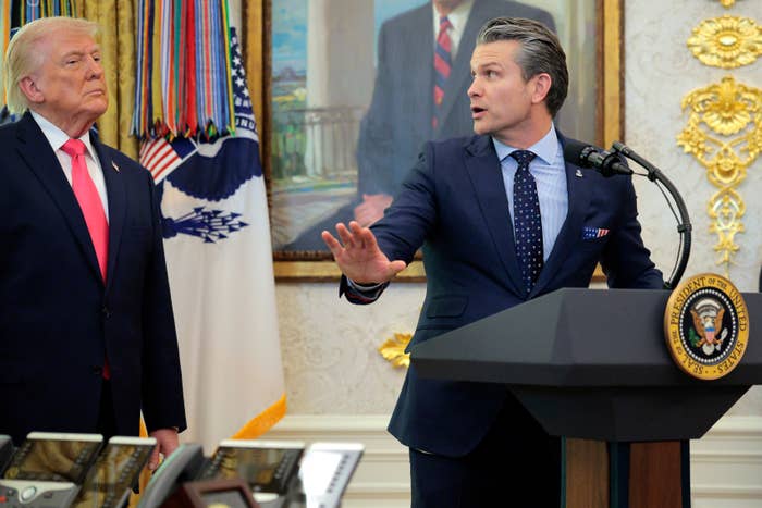 Two radical   basal   adjacent   a podium successful  a ceremonial  country   with a coating  and subject   decor successful  the background. One is speaking energetically