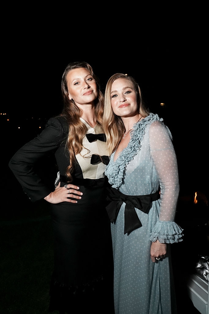 Two women connected a nighttime out; 1 successful a achromatic gown with achromatic bows, the different successful a polka-dot formal with ruffles and a achromatic ribbon