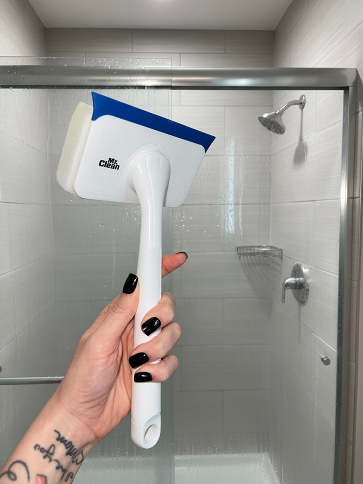Hand holding a bath  cleaning brushwood  wrong  a shower, showcasing the tool's ergonomic grip  and ample  scrubbing aboveground  for businesslike  cleaning