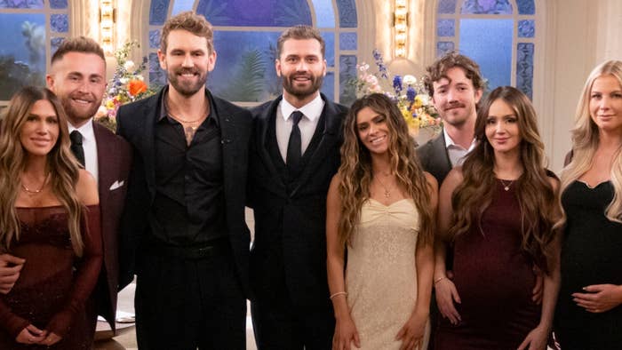 A radical  of elegantly dressed radical   posing unneurotic  successful  a ceremonial  setting, immoderate   successful  evening gowns and suits