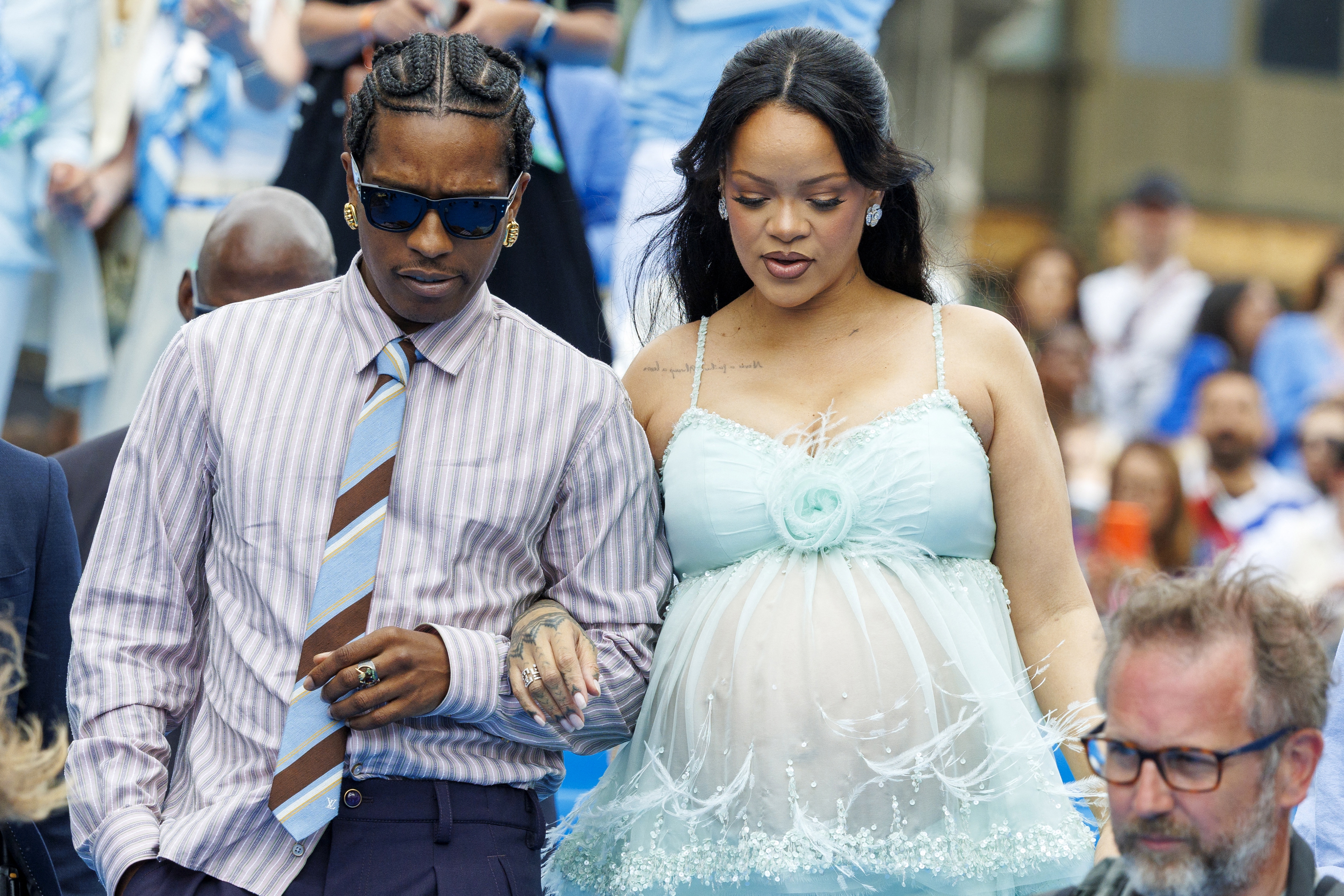 ASAP Rocky successful a striped garment and necktie and Rihanna successful a sheer apical with a babe bump