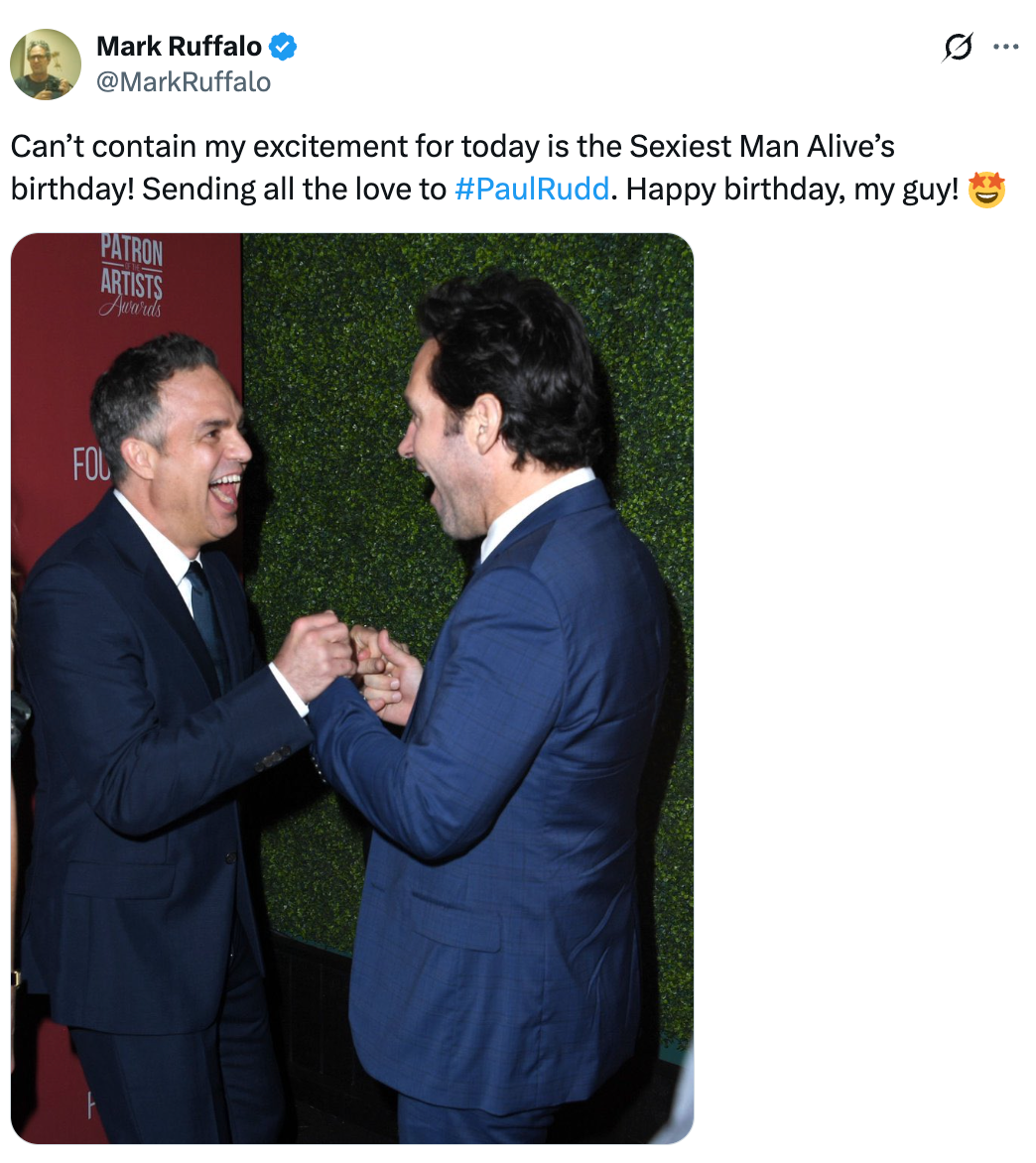 Two radical joyfully greet each different astatine an event, some wearing suits. The representation accompanies a tweet sending day wishes to Paul Rudd