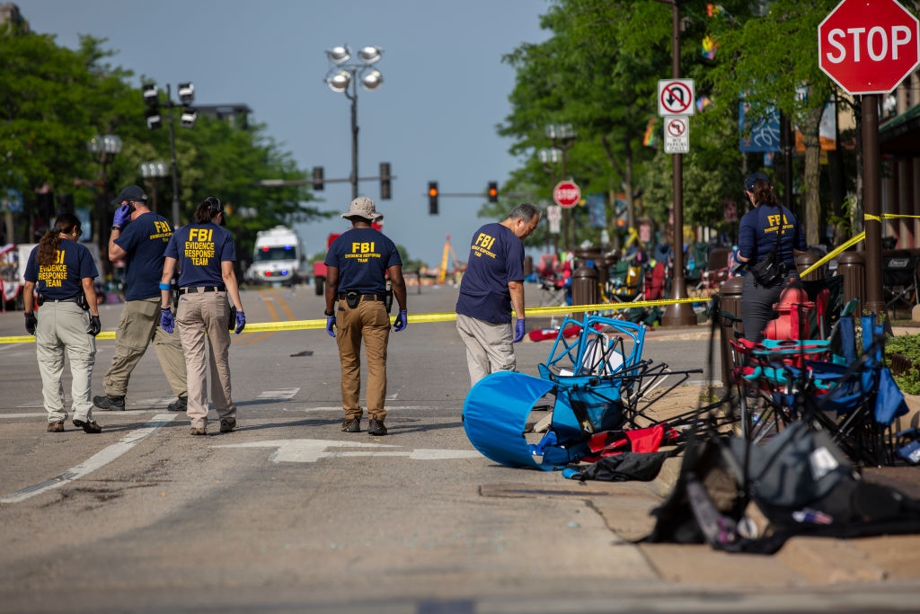 FBI agents analyse a transgression country connected a thoroughfare with overturned chairs and caution tape