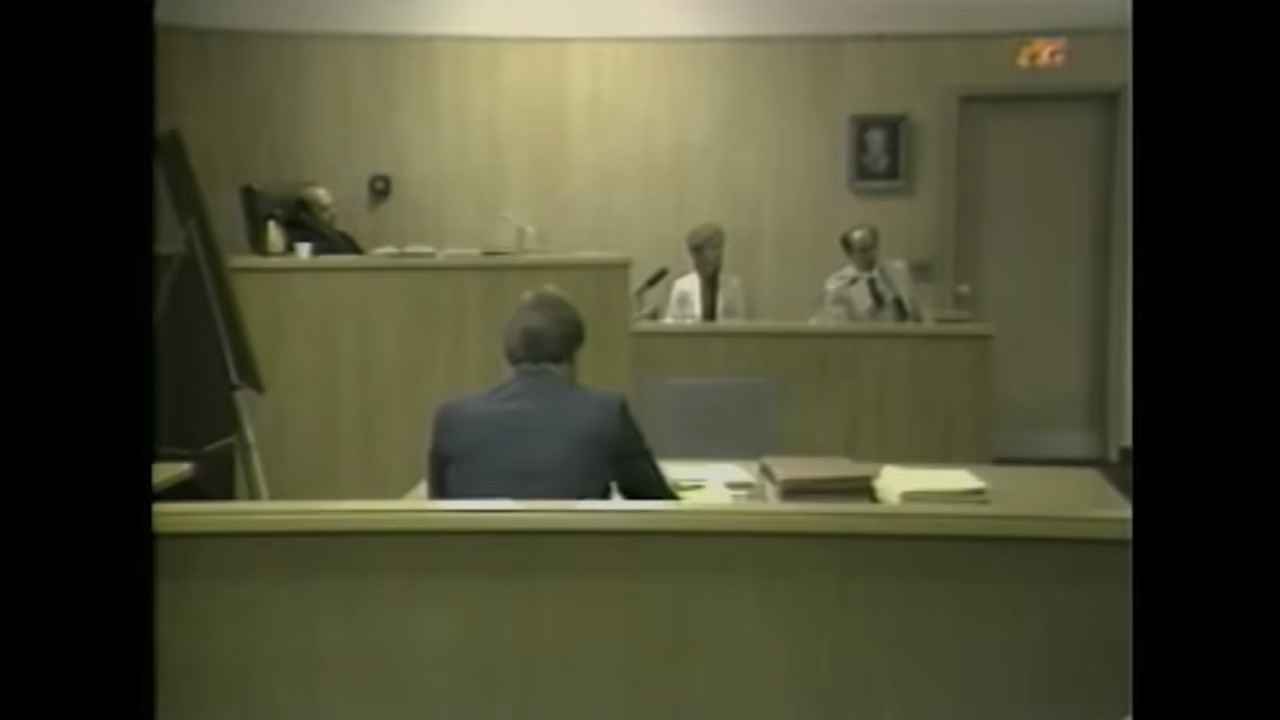 Courtroom with a justice seated astatine the bench, a lawyer facing the judge, and 2 officials observing from the side