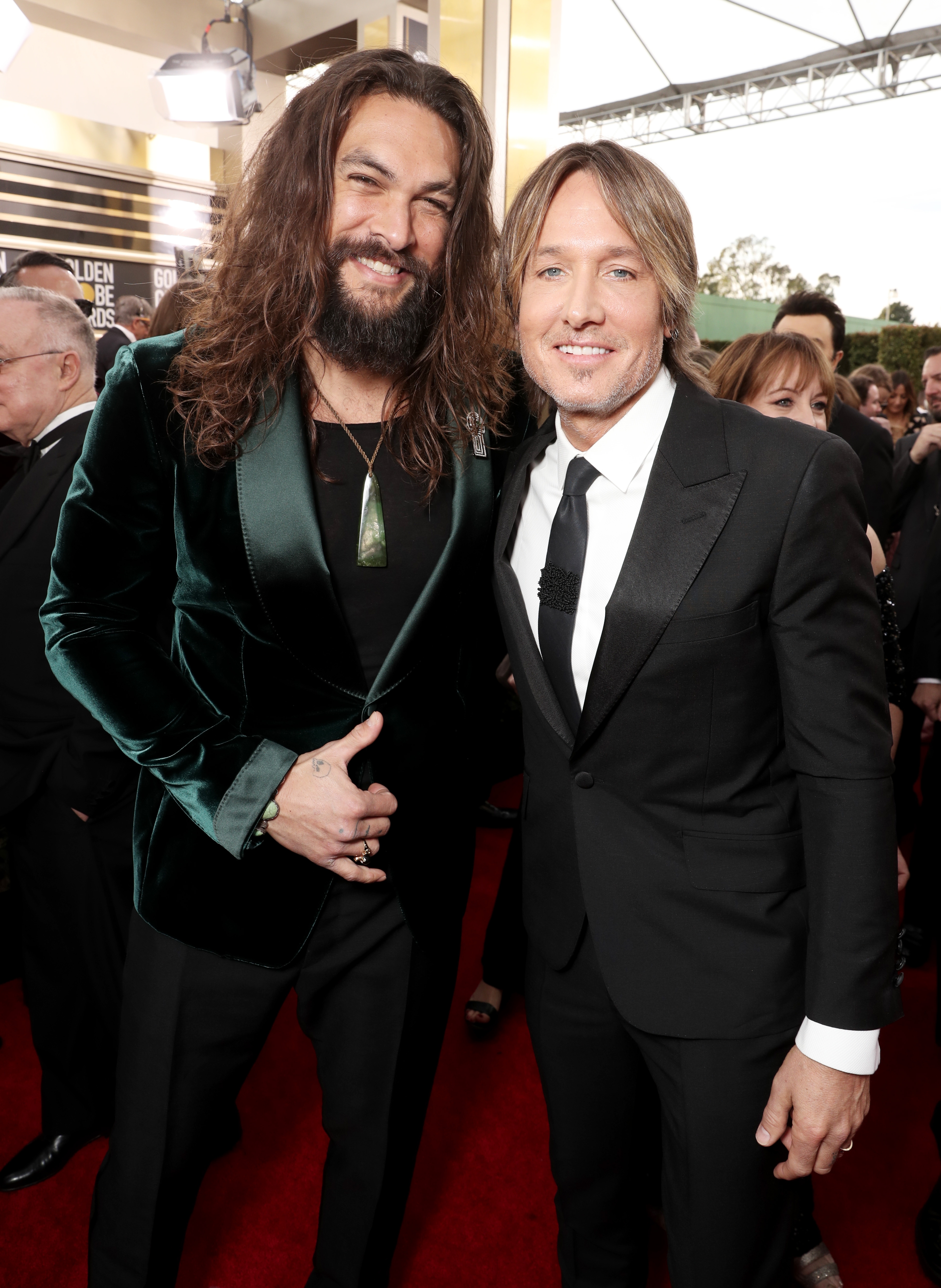 Two men airs  connected  a reddish  carpet. One wears a velvet suit, the different   a classical  tuxedo. They look  to beryllium  astatine  a ceremonial  event