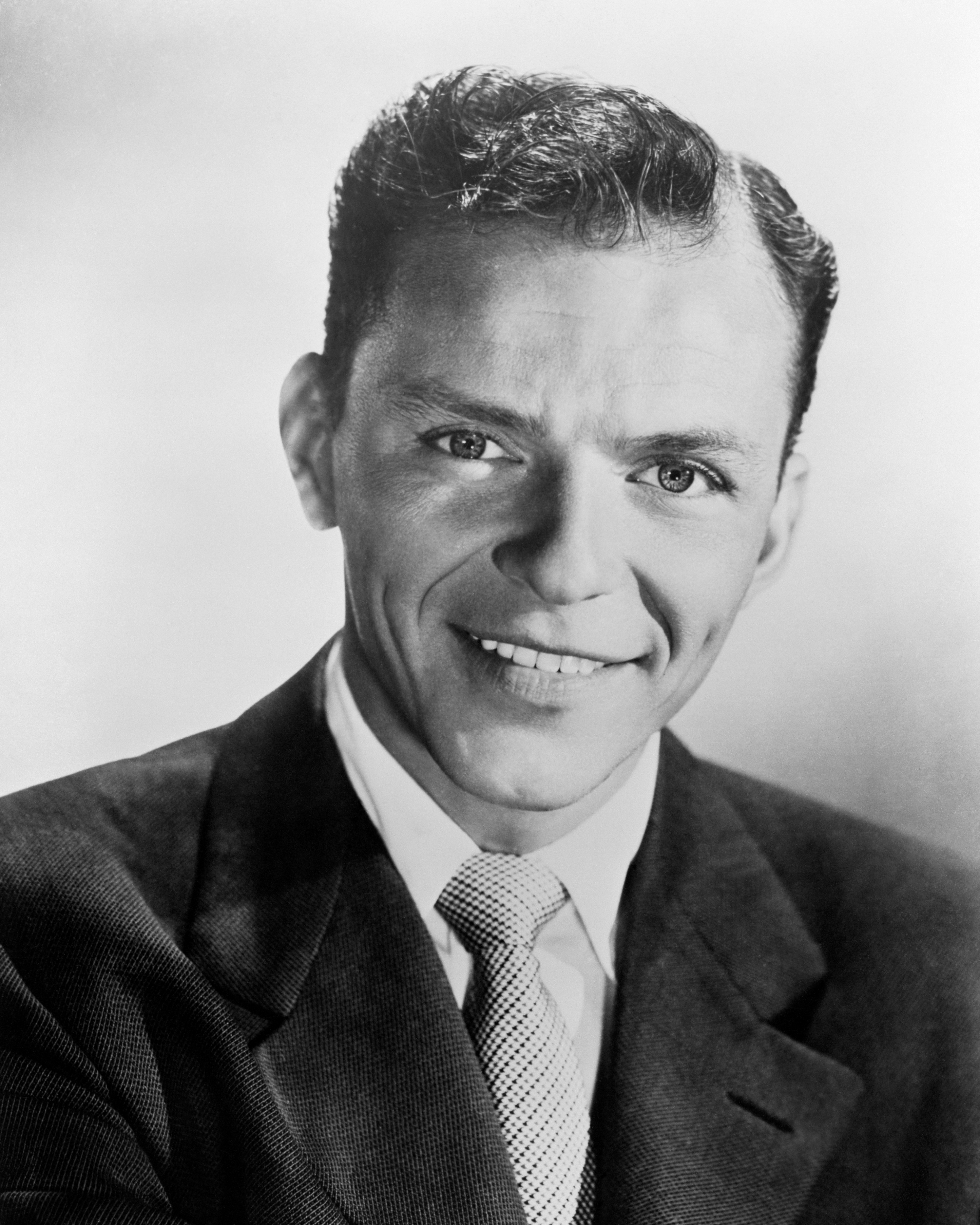 A idiosyncratic   successful  a classical  suit   and tie, smiling