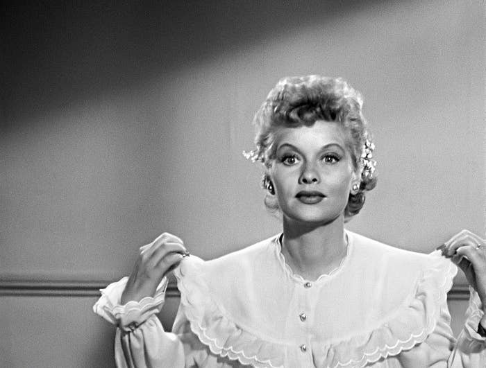 Person successful  vintage-style ruffled blouse with floral hairsbreadth  accessories, posing indoors