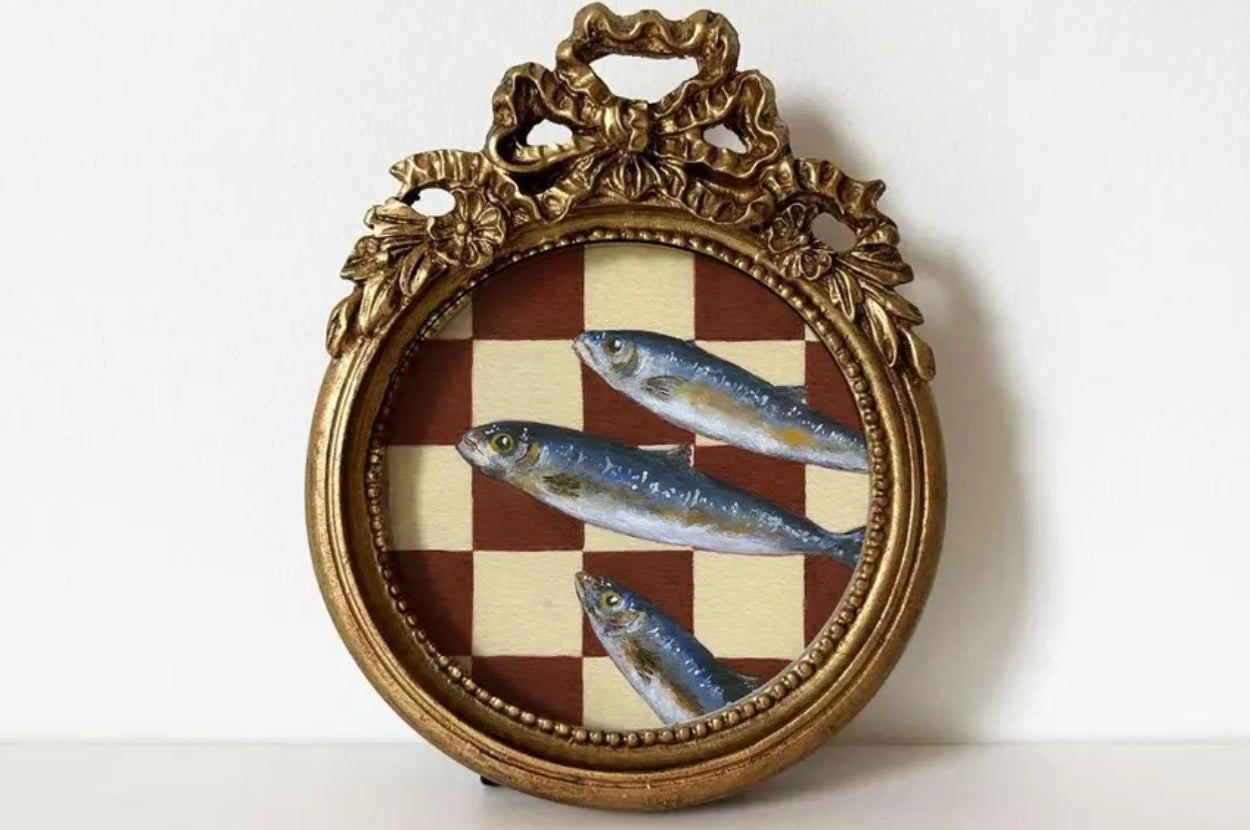 Ornate round frame with three fish on a checkered board design, highlighting a unique art piece perfect for home decor