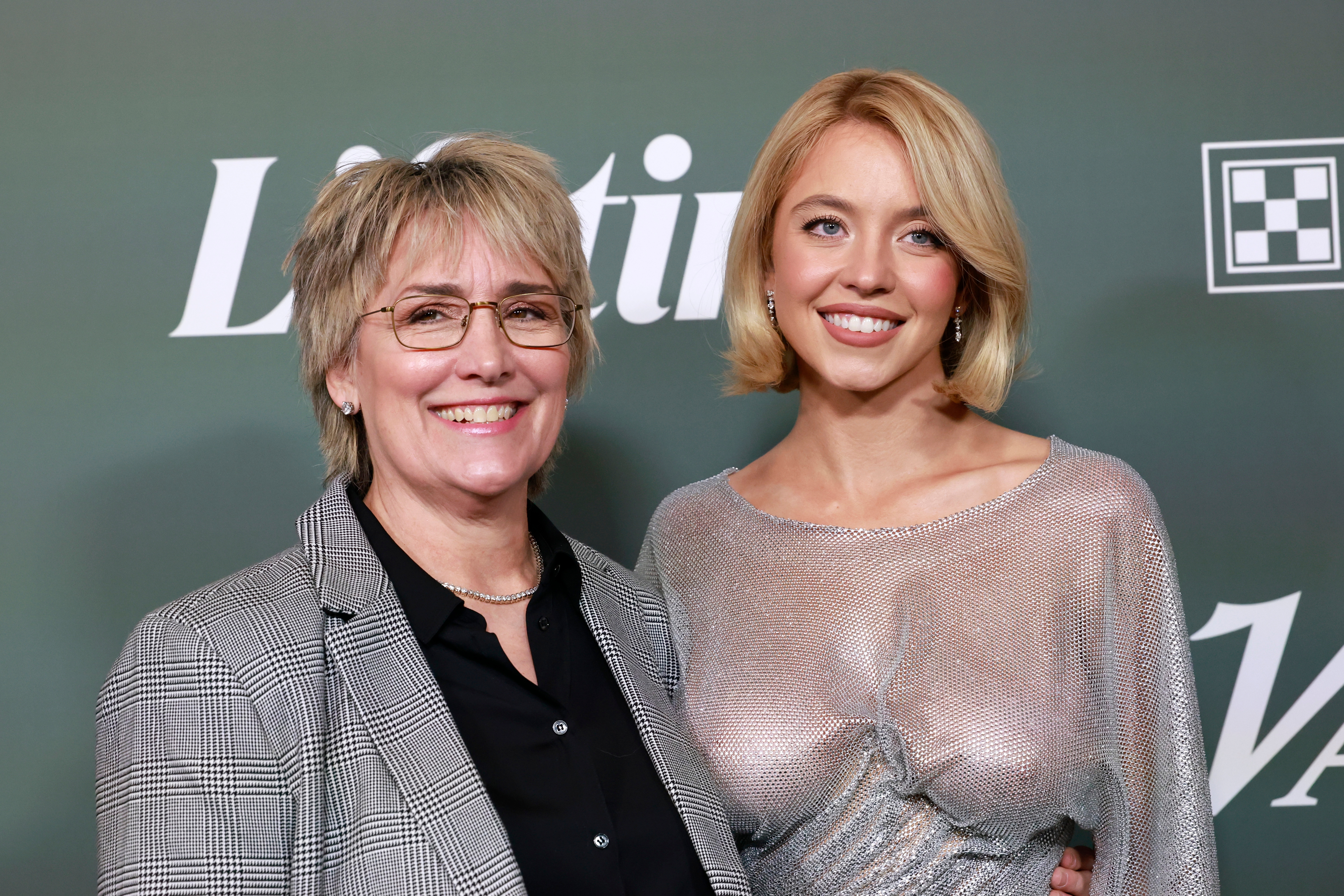 Two individuals airs  astatine  a Lifetime and Variety event. The idiosyncratic   connected  the near  wears a plaid blazer, and the idiosyncratic   connected  the close    wears a shimmering dress