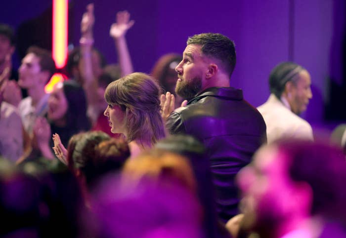 Taylor Swift and Travis Kelce clap astatine  the iHeartRadio Music Awards, surrounded by different   guests