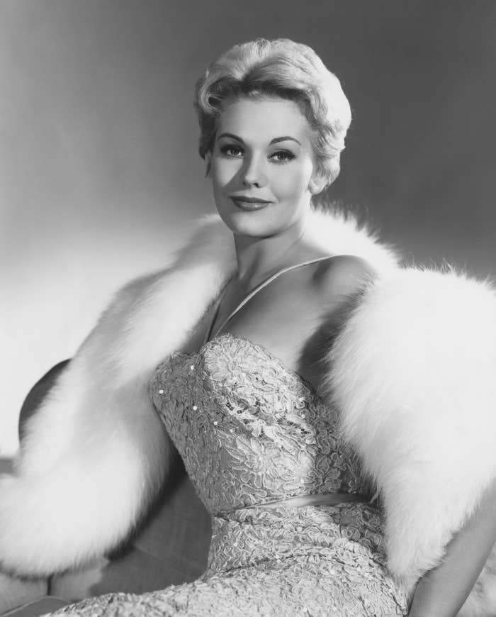Person successful  an elegant lace gown with a fur stole, posing gracefully