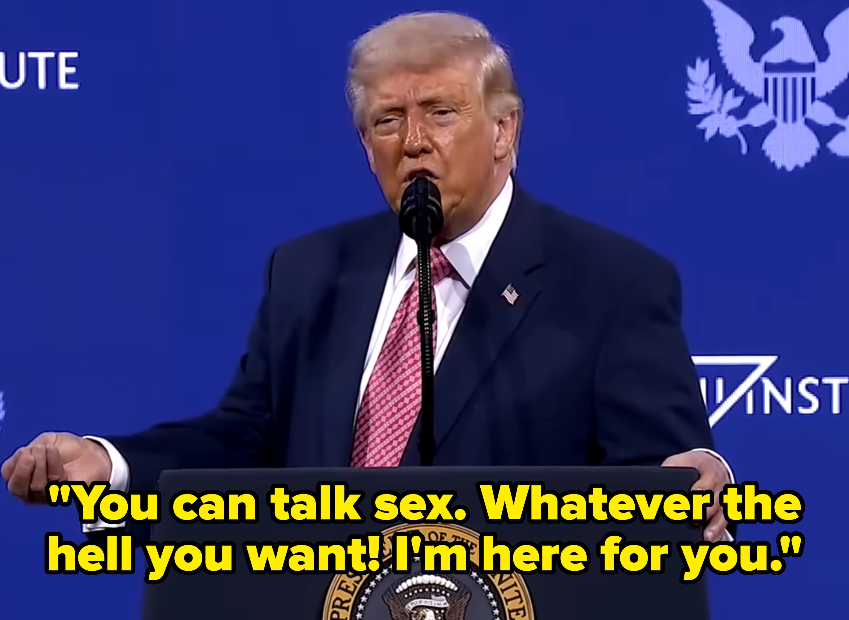 A idiosyncratic speaking astatine a podium with a Presidential seal, acceptable against a backdrop with logos and icons successful the benignant of a authorities oregon governmental event